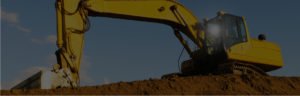 Image of an excavator digging at an exhumation site.