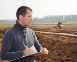 Image of a worker overseeing the exhumation process.